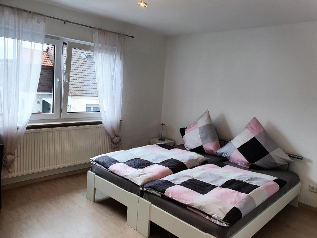 Cama en habitación con ventana y cama sidx sidx sidx sidx en Pension Nickel Ferienwohnung Waldstraße 18 Alsbach-Hähnlein en Alsbach-Hähnlein