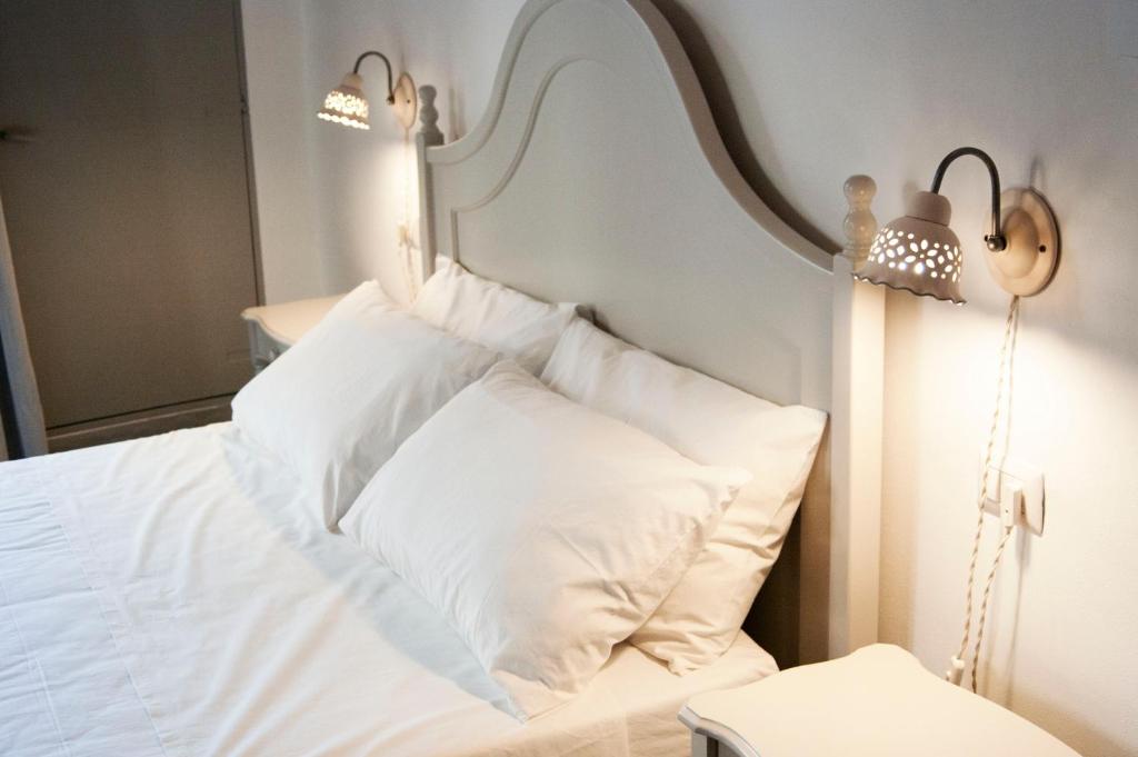 Posteľ alebo postele v izbe v ubytovaní Le Finestre Su Porta Carrese - Luxury Rooms