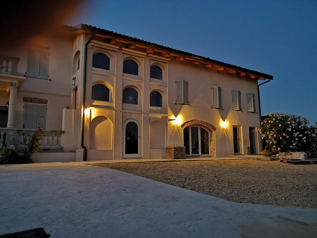 a large white building with a lot of windows at Theresa sulla Collina in Passerano 
