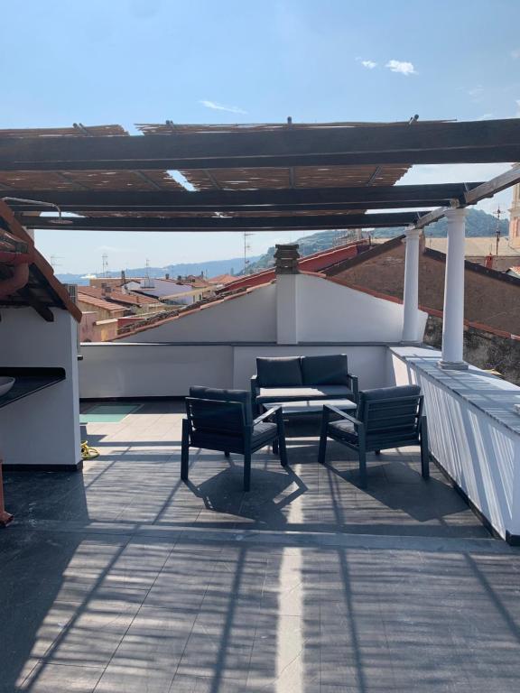 a patio with two benches on top of a roof at Casa del Poeta in Riva Ligure