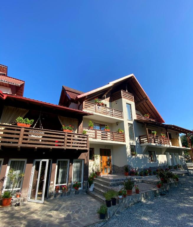 a large building with balconies and plants on it at Vila Sorina in Borşa