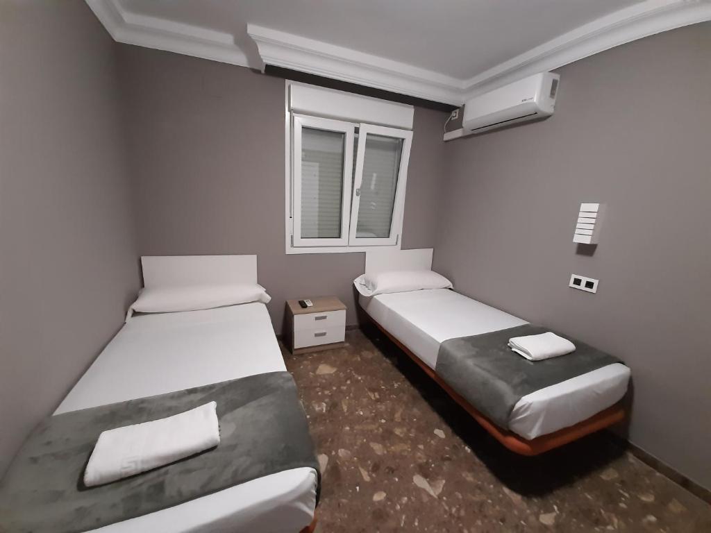 A bed or beds in a room at AYAMONTE ROOMS 43