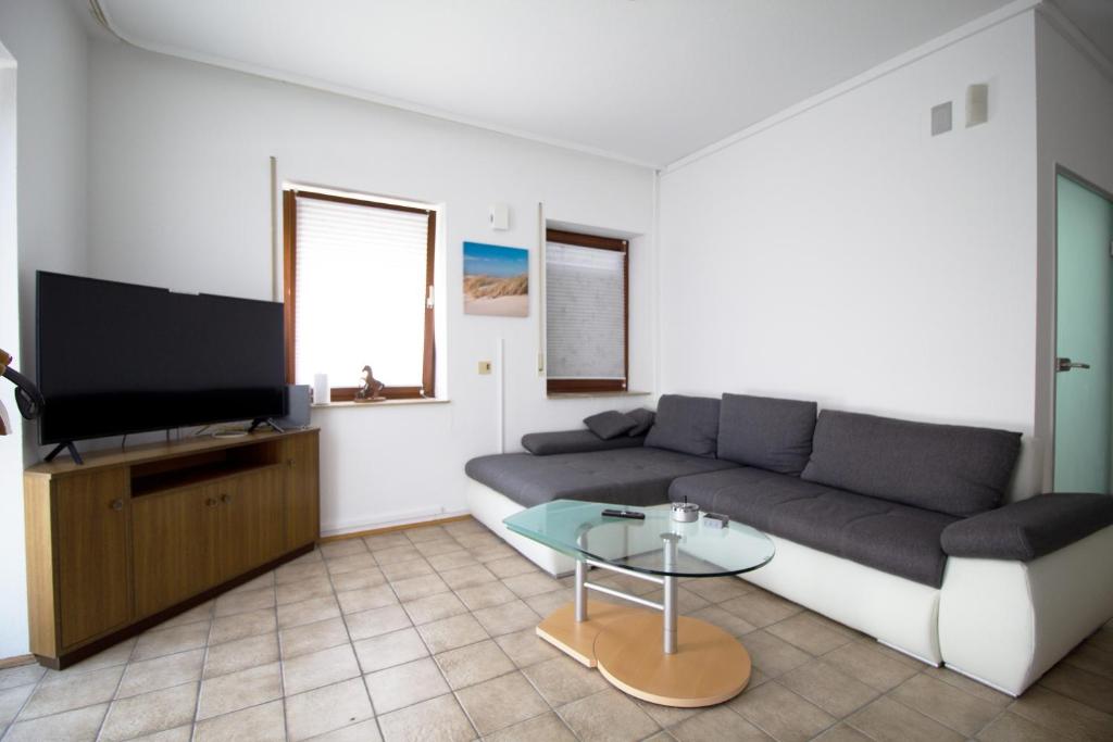 sala de estar con sofá y TV en Work & Stay in Niederstotzingen, en Niederstotzingen