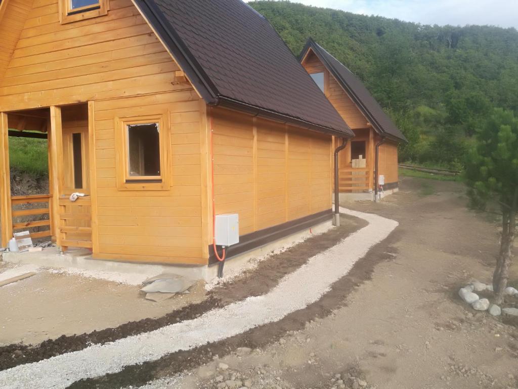 a house being constructed with a building at Camp Volujak in Volujak