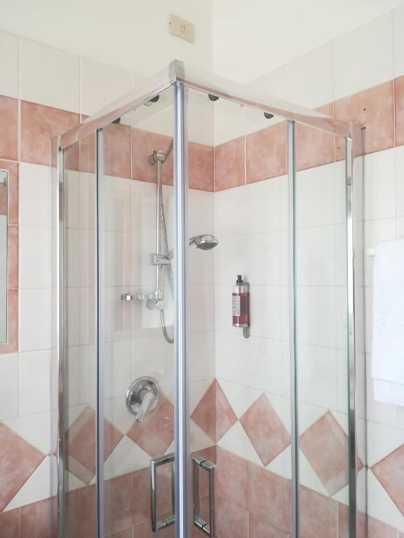 a shower with a glass enclosure in a bathroom at Hotel Primavera in Peschiera del Garda