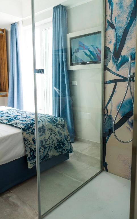 Postel nebo postele na pokoji v ubytování Piccolo Hotel
