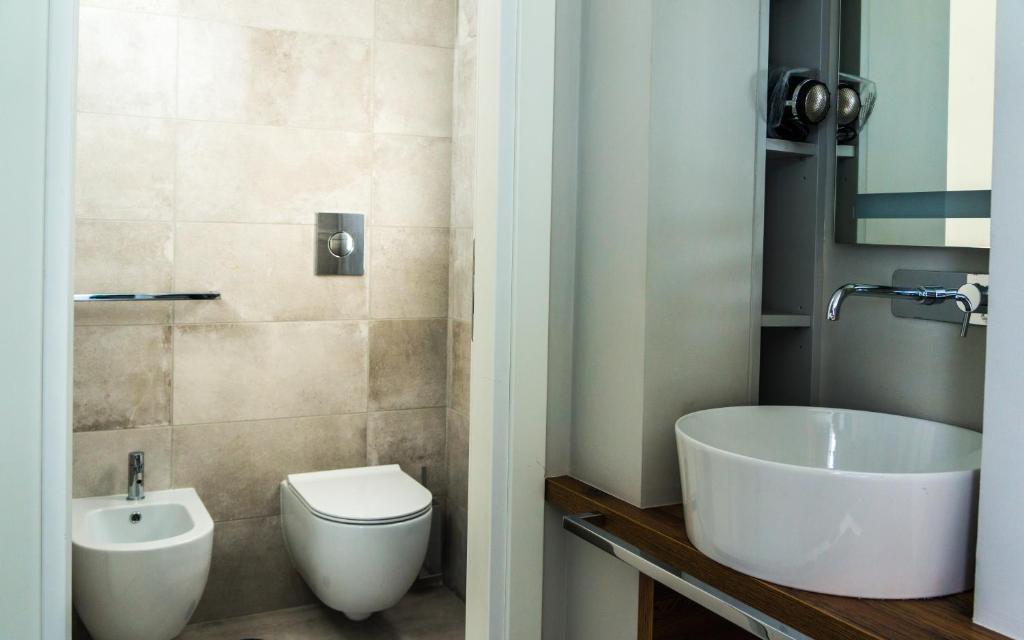 Koupelna v ubytování Piccolo Hotel