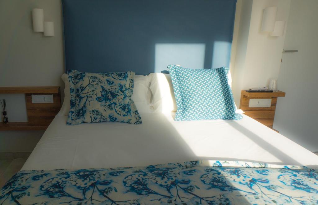 Postel nebo postele na pokoji v ubytování Piccolo Hotel