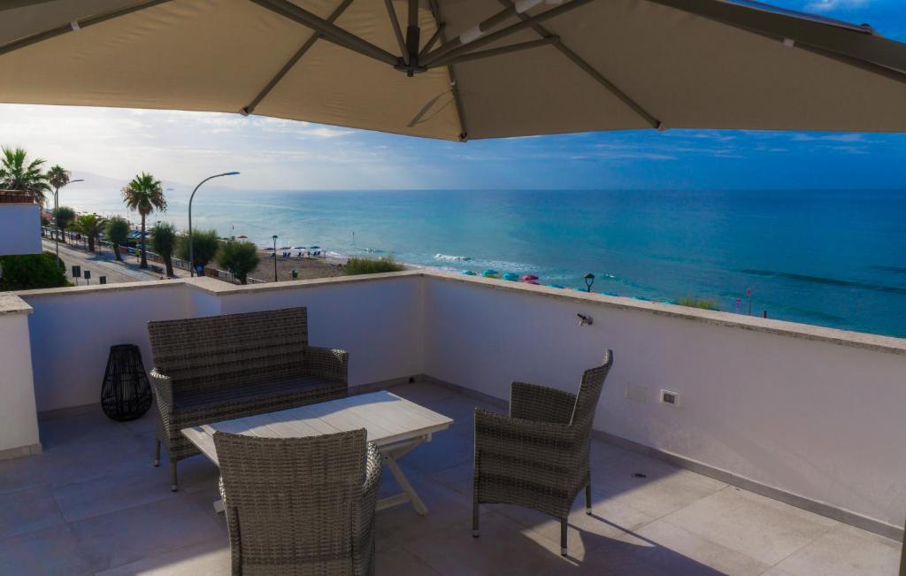 a balcony with a table and chairs and the ocean at Piccolo Hotel in Terracina
