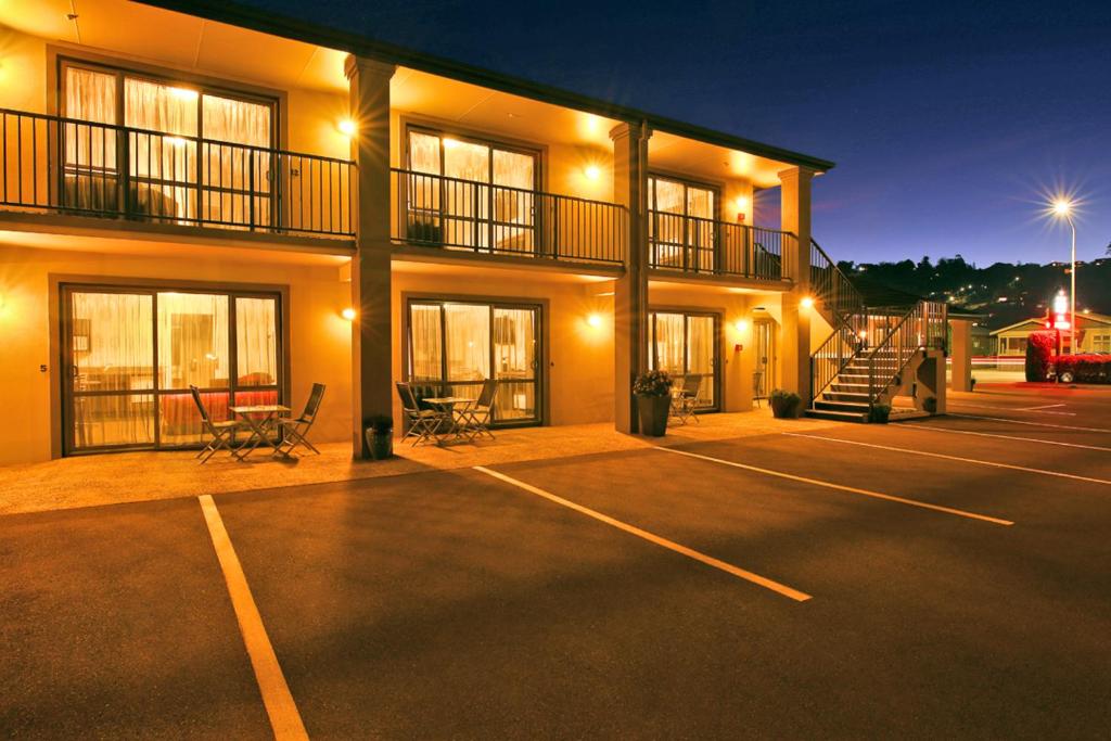 a parking lot in front of a building at night at Oamaru Motor Lodge in Oamaru