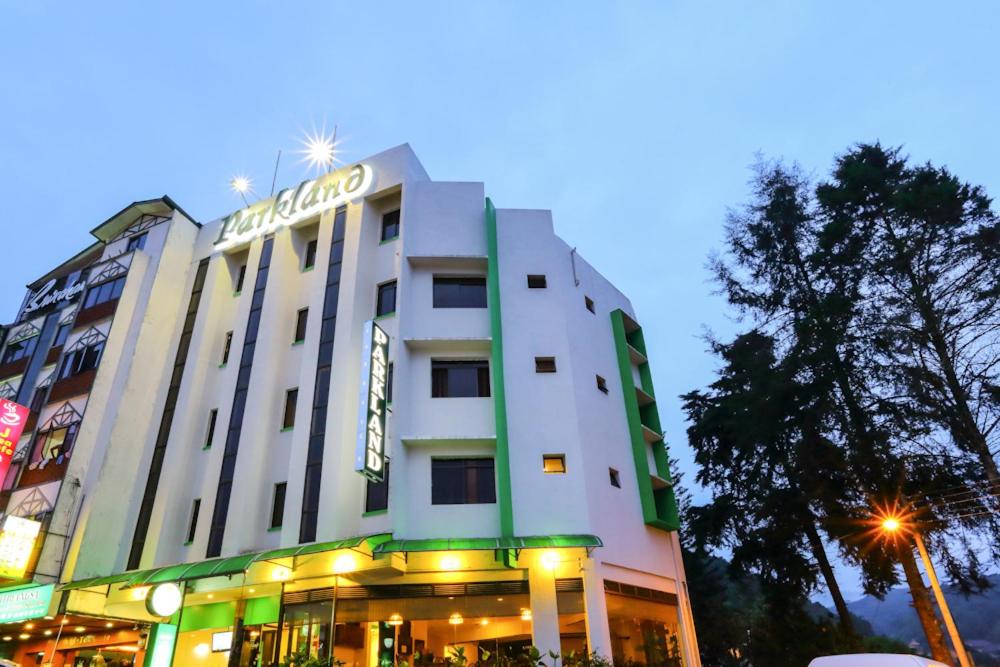 a building with a sign on top of it at Parkland Hotel in Brinchang