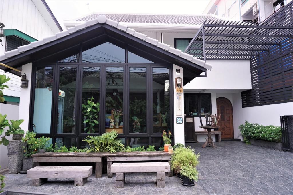 a building with a screened in porch with benches at Baan Lung Poshtel in Chiang Mai