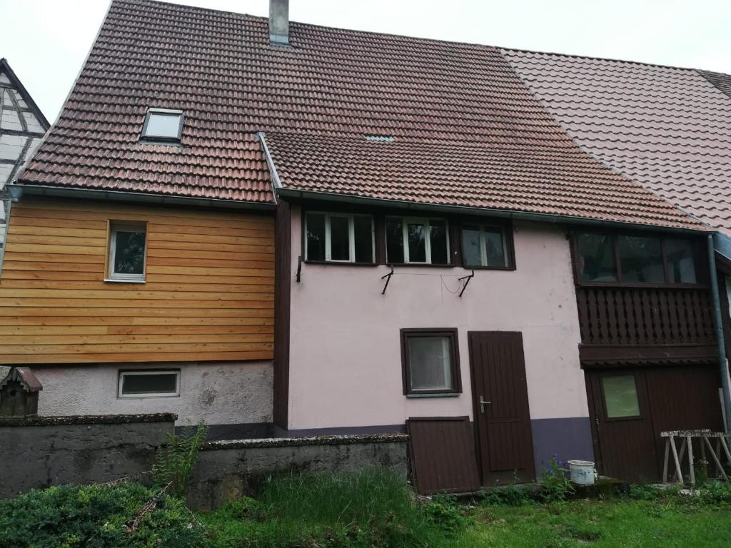 a white house with a brown roof at Häusle an der Hüle in Hohenstein