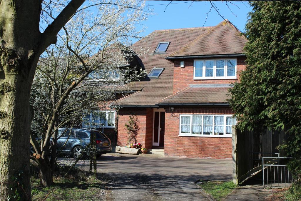 a brick house with a car parked in the driveway at Oxfordbnb in Oxford