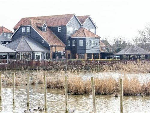 a group of houses and ducks in the water at Oyster Fleet Hotel in Canvey Island