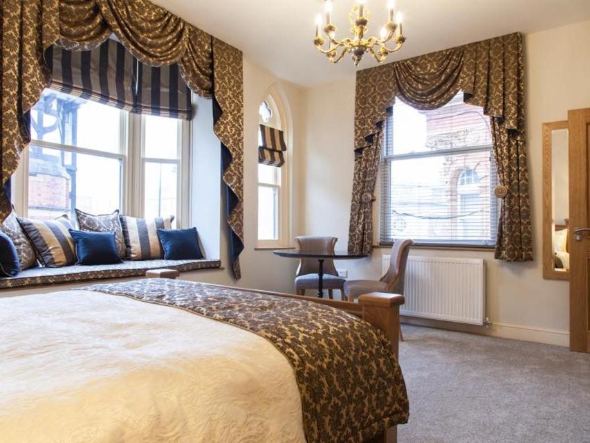 a bedroom with a large bed and two windows at Parkers House Bed & Breakfast in Newtown