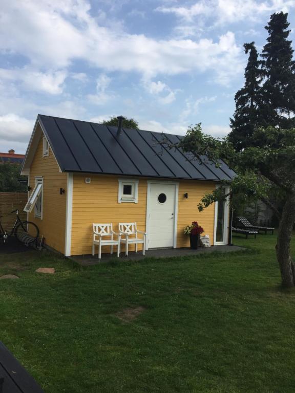 une maison jaune avec un toit noir dans l'établissement Annexet, à Jönköping
