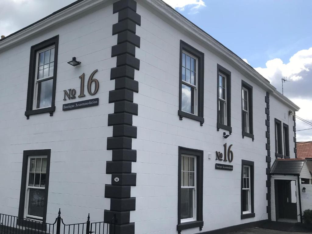 a white building with black windows and a pole at No.16 in Seaham