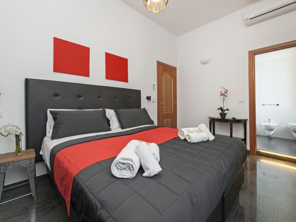 a bedroom with a large bed with towels on it at Retro Rooms Termini in Rome
