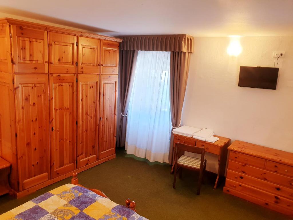 Posteľ alebo postele v izbe v ubytovaní Albergo Trieste