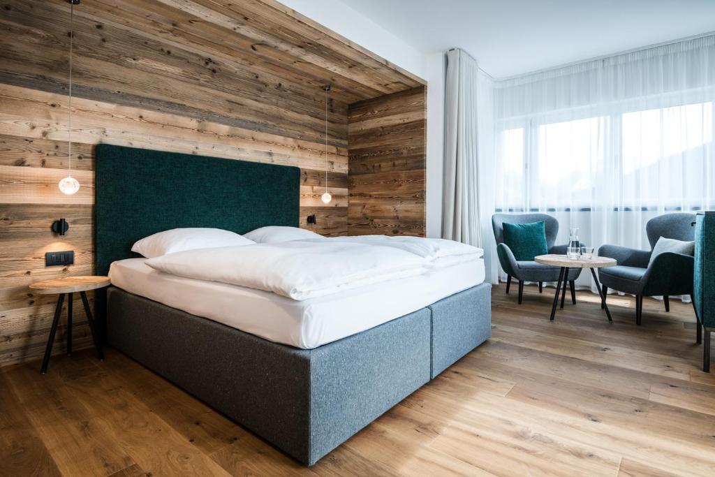 Łóżko lub łóżka w pokoju w obiekcie Hotel Ciasa Tamá