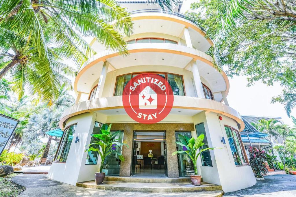 a building with a red sign on it at Suan Palm Garden View in Rayong