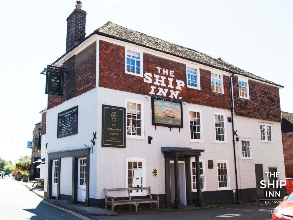 a building with a sign that reads the slip inn at The Ship Inn in Rye