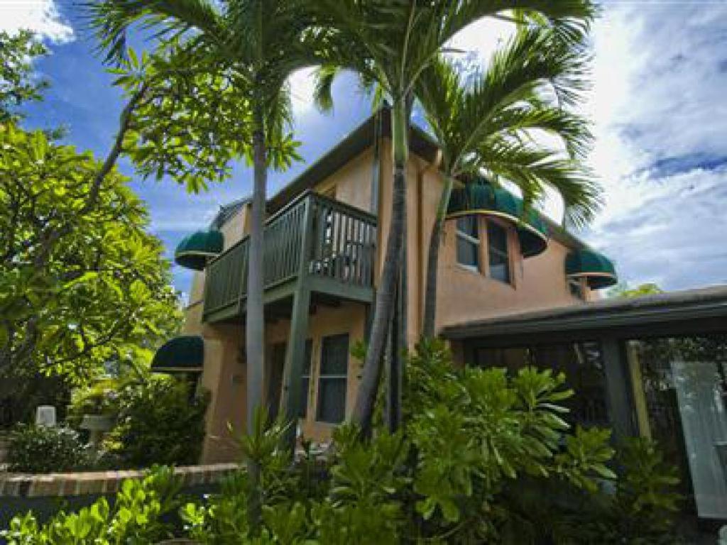 una casa con palmeras delante en Suite Dreams Inn by the Beach, en Key West