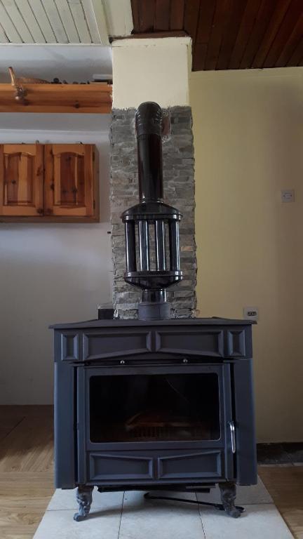 a black stove with a heater on top of it at Kućica za odmor-Borova glava in Zlatibor