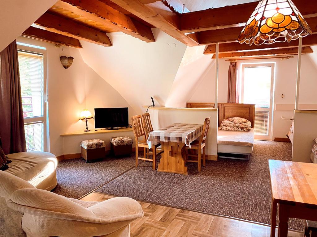 a living room with a couch and a table at Villa Cecylia in Zakopane