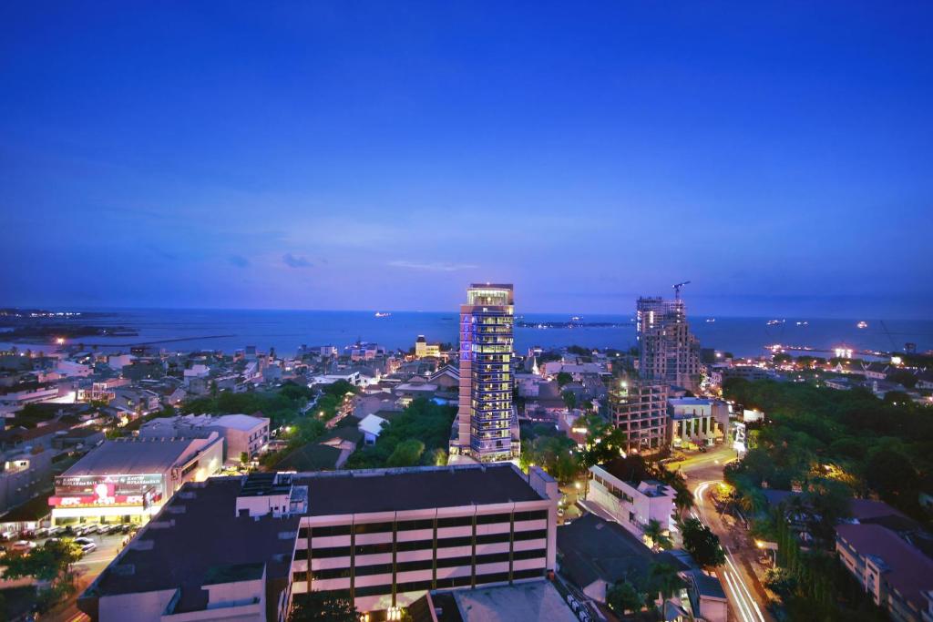 a view of a city at night at ASTON Makassar Hotel & Convention Center in Makassar