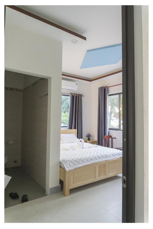 Postel nebo postele na pokoji v ubytování Chamisland Hanhly homestay