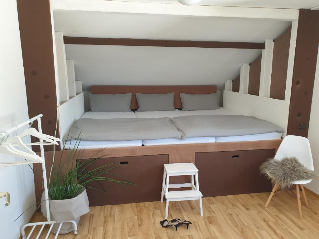 a bed in a loft bed room with a ladder at Studio 11 in Neuffen