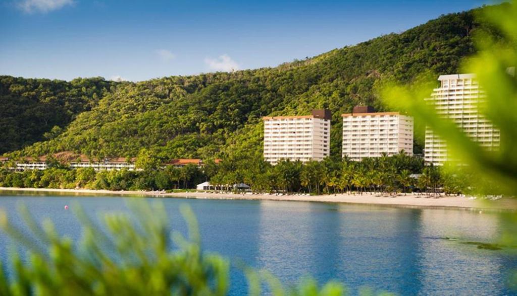 a group of buildings on the shore of a body of water at Whitsunday Apartments in Hamilton Island