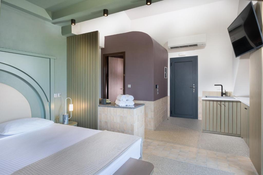 Postel nebo postele na pokoji v ubytování Callisti Suites