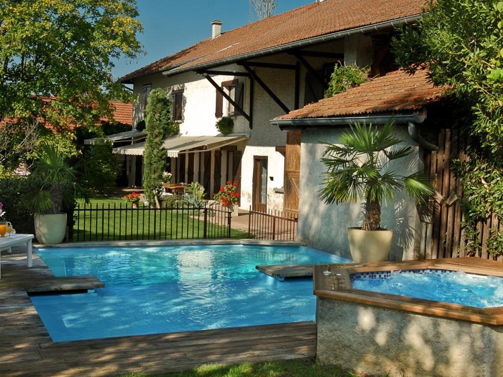 a swimming pool in front of a house at Le Domaine du Plantier in Saint-Hilaire-de-la-Côte