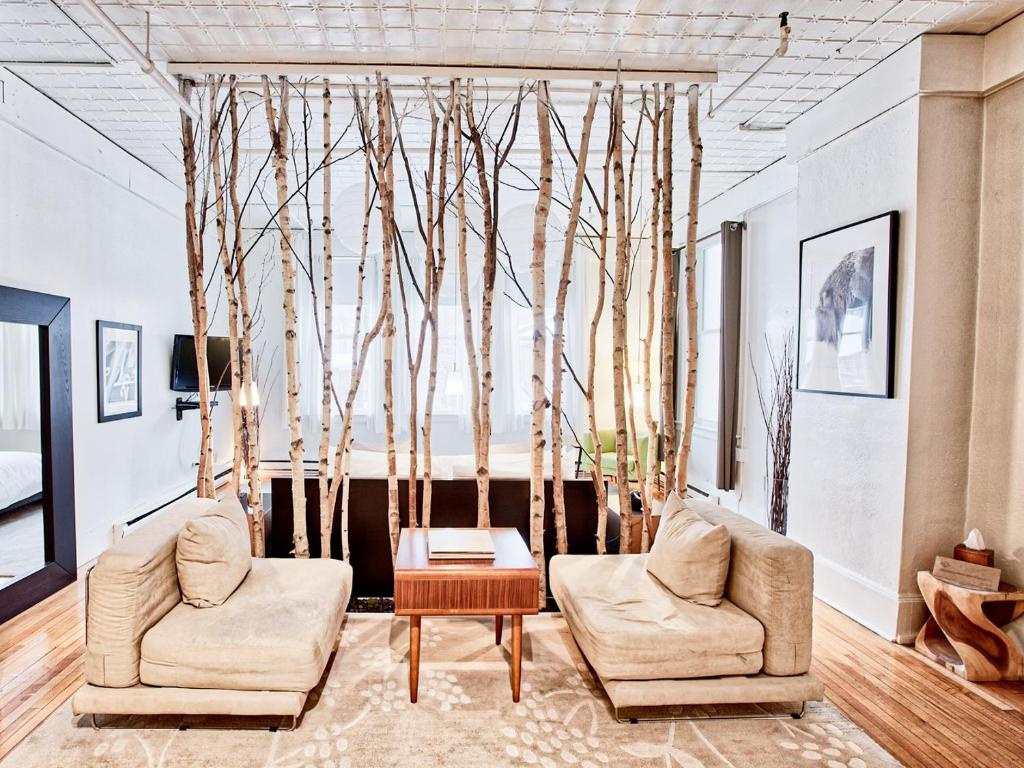 a living room with two chairs and a table at The Haus On Mirror Lake in Lake Placid