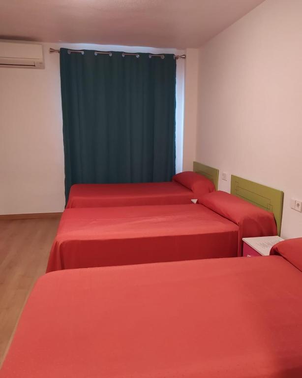 Postel nebo postele na pokoji v ubytování Hostal Rosa