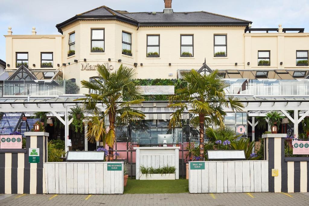 
a large building with palm trees and palm trees at The Martello Hotel in Bray
