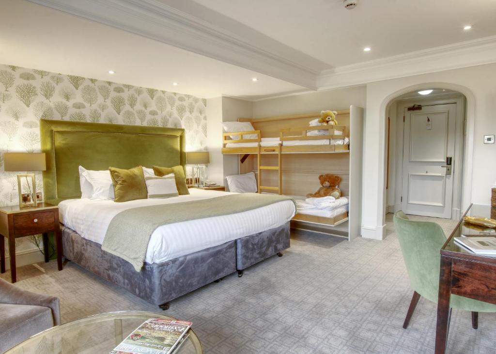 a hotel room with a large bed and a desk at Thurlestone Hotel in Thurlestone