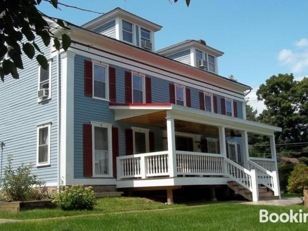 a large blue house with red and white windows at Tin Brook Bed & Breakfast in Walden