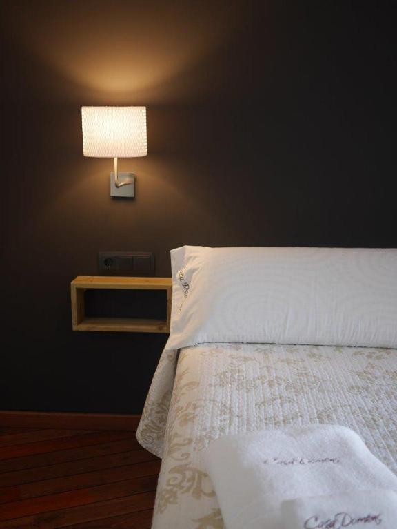 Postel nebo postele na pokoji v ubytování Hotel Casa Domenc