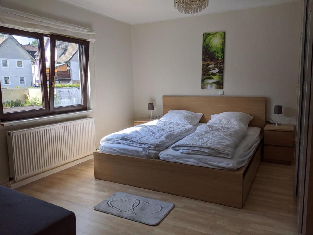 a bedroom with a bed and a window at Zur ForsHütte in Braunlage