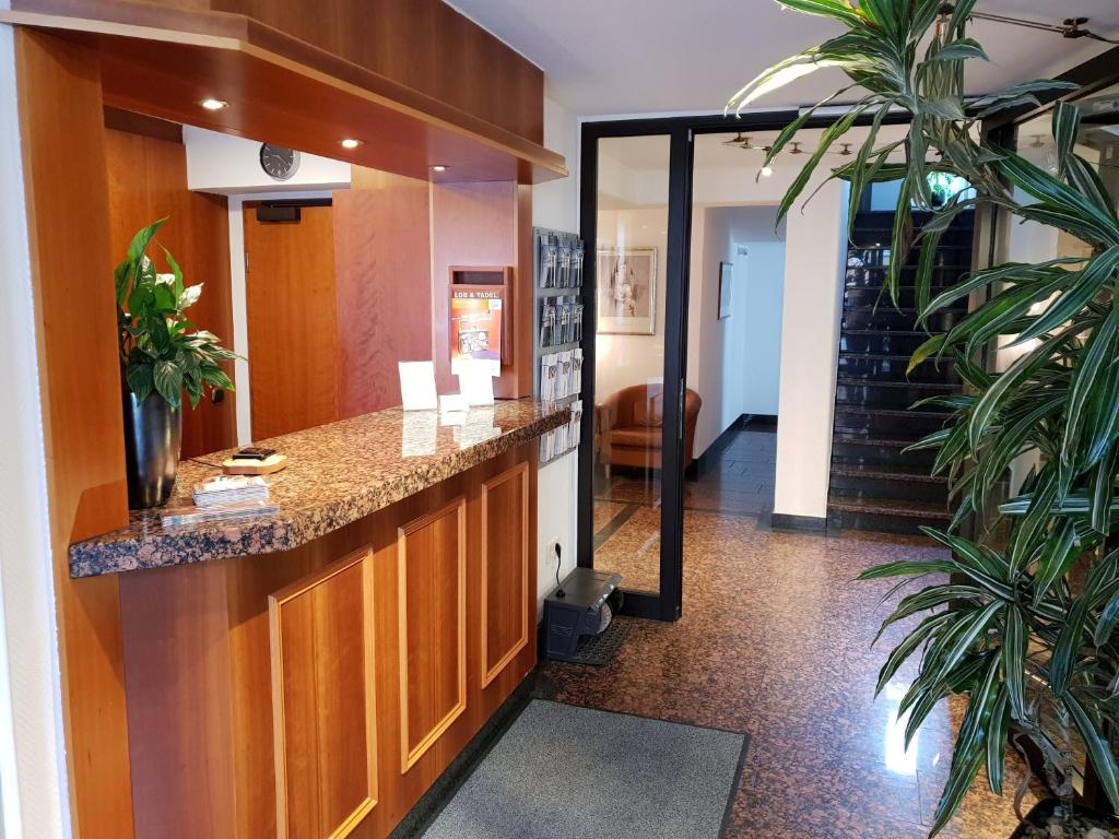 a lobby with a reception counter in a building at City Hotel Stuttgart in Stuttgart