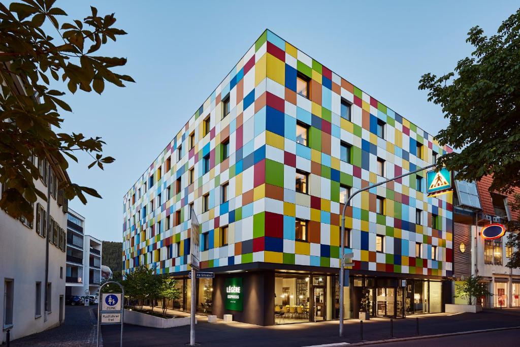 a building with a colorful facade on a street at LÉGÈRE EXPRESS Tuttlingen in Tuttlingen