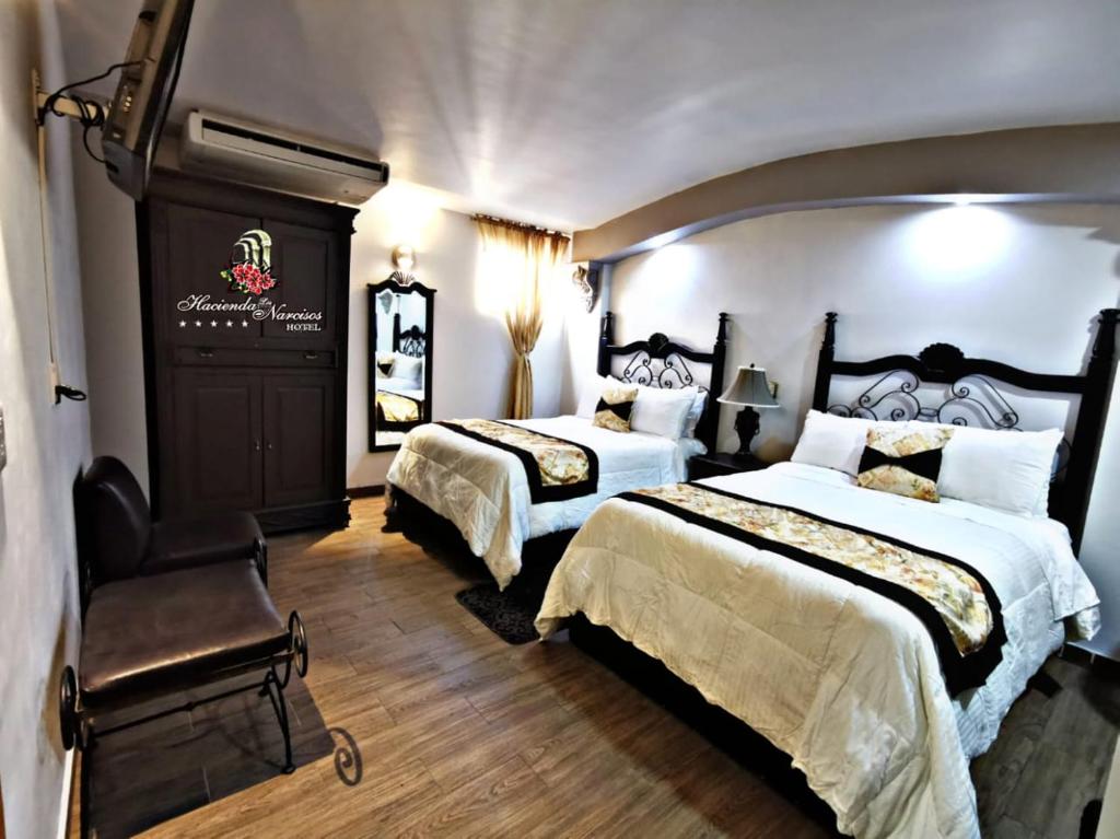 Postel nebo postele na pokoji v ubytování Hotel Hacienda los Narcisos