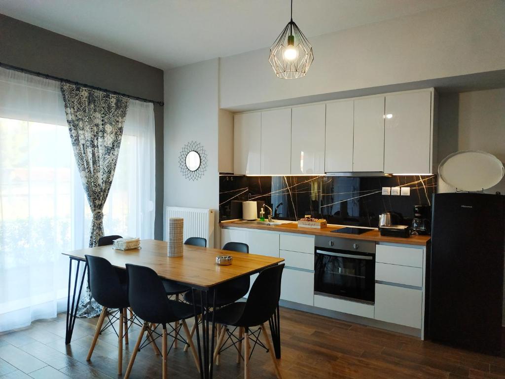 a kitchen with a table and chairs and a dining room at Meteora Rocks Apartment 1 in Kalabaka