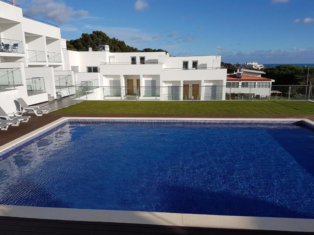 a villa with a swimming pool in front of a house at " Villa Ocean View over the Sea " - A in Albufeira