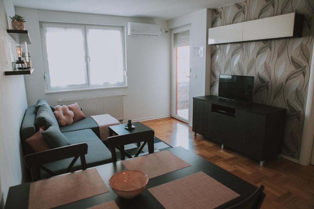 a living room with a couch and a tv at Apartment Nika, Arena Zagreb in Zagreb