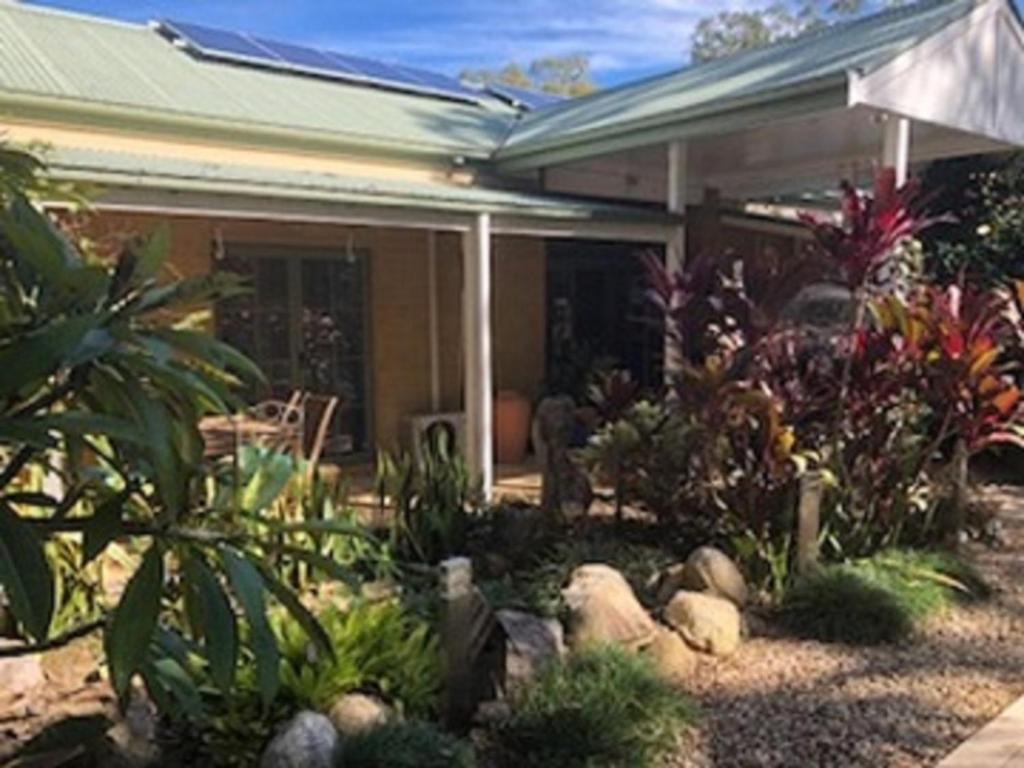 a garden in front of a house with plants at Smoky Cape Retreat in South West Rocks